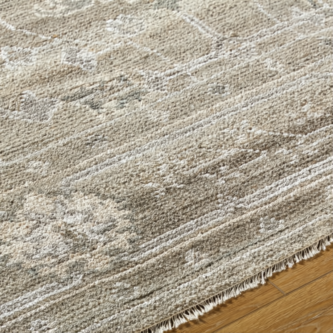 Surya Almeria low pile hand-knotted rug in light brown, medium gray, and cream with fringe.