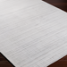 Surya Fresno FNO-2303-P white hand-loomed recycled PET yarn rug with subtle texture on dark wood floor.