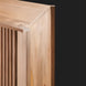 Close-up of a light brown lacquered mango wood cabinet with vertical fluted details on the door.