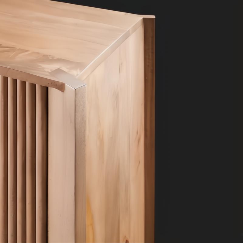 Close-up of a light brown lacquered mango wood cabinet with vertical fluted details on the door.
