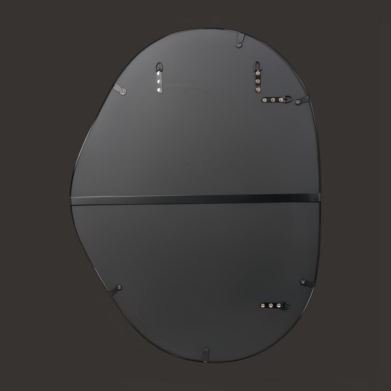 Back of a black iron-framed Surya Aamnah wall mirror with mounting hardware.