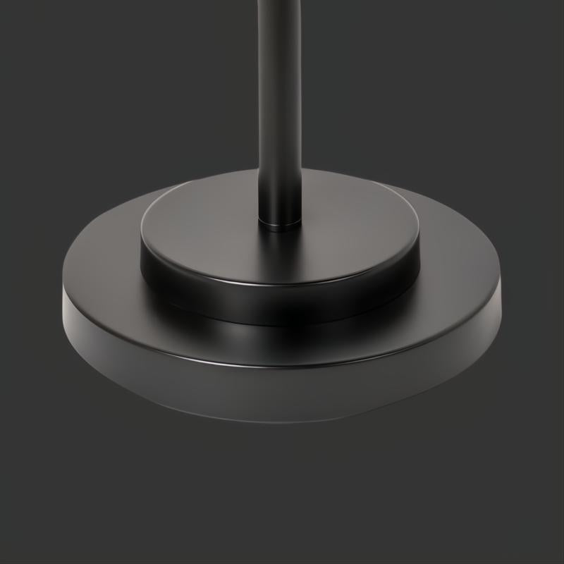 Close-up of the Aberdeen accent floor lamp's round black metal base.
