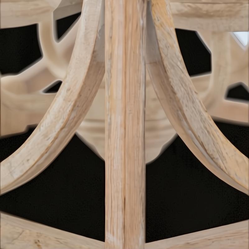 Close-up of the Surya Braylee 4-light chandelier's distressed wood and metal frame, showcasing its classic design.