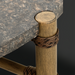 Charcoal matte stone top outdoor coffee table with brown hand-painted aluminum base and PE rope detail.