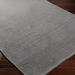 Surya Azalea AZA-2316 light gray hand-woven recycled PET yarn area rug with subtle texture on dark wood floor.