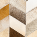 Surya Appalachian Ottoman with a hair on hide cover in ivory, brown, and medium gray chevron pattern.