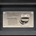 Close-up of a black hand-painted aluminum fire table's silver control panel with lighting instructions and an "OFF" to "HI" knob.