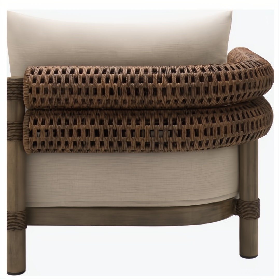Brown woven rattan armrest and light beige cushion of a Surya Porta outdoor sectional.
