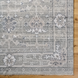 Surya Almeria low pile area rug in sage green with traditional floral and geometric patterns.