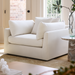 Surya Capitola white polyester-linen accent chair with three pillows, 47"W, in a living room.