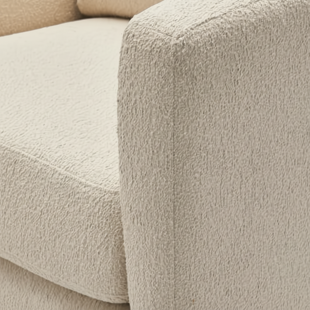 Close-up of a beige textured polyester swivel chair with structured, squared arms.