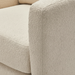 Close-up of a beige textured polyester swivel chair with structured, squared arms.