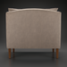 Back view of a light brown upholstered Surya Maywood accent chair with dark brown rubber wood legs.