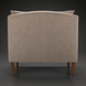 Back view of a light brown upholstered Surya Maywood accent chair with dark brown rubber wood legs.