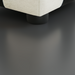 Close-up of a Surya Elenora modular chair corner, showing taupe polyester upholstery and a dark rubber wood leg.
