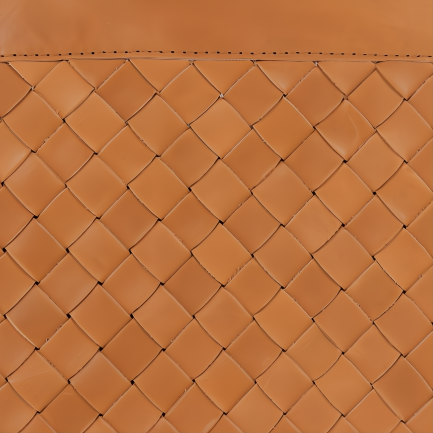 Close-up of a brown leather ottoman with a woven diamond pattern and stitched top edge.