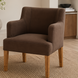 Surya Monay dining chair with chocolate brown upholstery and oak wood legs, featuring a global eclectic style.