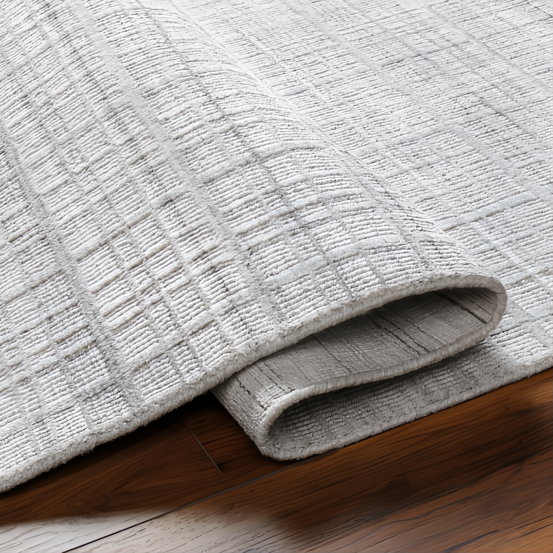 Light gray Surya Fresno area rug, hand-loomed from recycled PET yarn, with a subtle grid pattern.