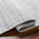 Light gray Surya Fresno area rug, hand-loomed from recycled PET yarn, with a subtle grid pattern.