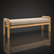 Surya Palma outdoor bench with light teak wood frame, woven arm accents, and beige Sunbrella cushion.