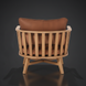 Surya Arco accent chair with brown leather cushions and a natural beechwood slatted back and base.
