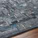 Surya Calgary CGR-2305-P hand-tufted rug with teal, charcoal, and gray abstract pattern on wood floor.