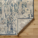 Hand-knotted Surya Cappadocia wool area rug with traditional charcoal, wheat, and taupe pattern, low pile, and fringe.