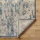Hand-knotted Surya Cappadocia wool area rug with traditional charcoal, wheat, and taupe pattern, low pile, and fringe.