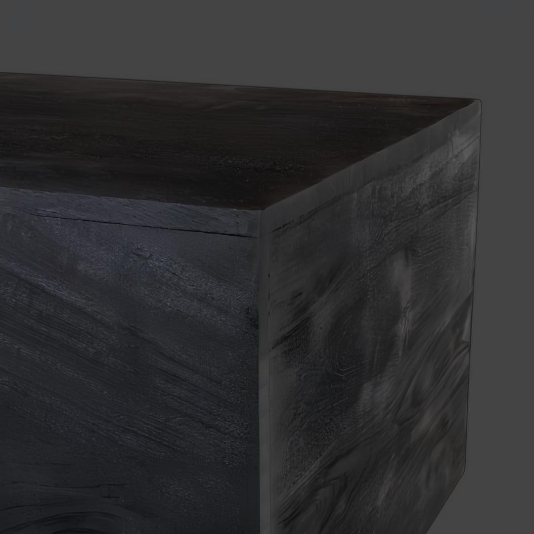 Close-up of a Surya Neemrana rectangular coffee table in black brushed solid acacia wood, showing exposed grain.