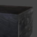 Close-up of a Surya Neemrana rectangular coffee table in black brushed solid acacia wood, showing exposed grain.