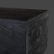 Close-up of a Surya Neemrana rectangular coffee table in black brushed solid acacia wood, showing exposed grain.