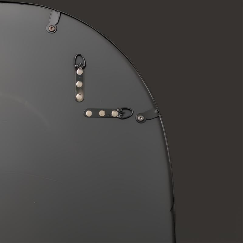 Back of a Surya Aamnah wall mirror showing black iron frame and vertical/horizontal mounting hardware.
