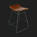 Modern Surya Celerio counter stool with brown lacquered leather seat and gray powder-coated iron base.
