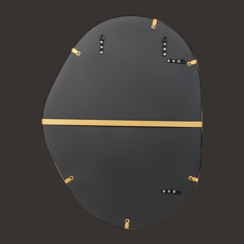 Back of a Surya Aamnah AMH-001 wall mirror, showing gold-toned iron frame and mounting hardware.