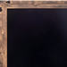 Surya Alchemist rectangular wall mirror with a hammered gold iron frame and beveled glass.