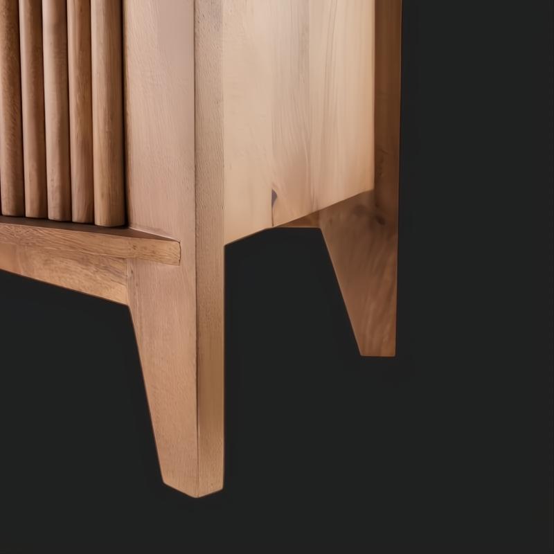 Close-up of the Surya Ronan Cabinet's brown lacquered mango wood, showing slatted door and tapered legs.