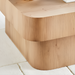 Surya Arquette modern square coffee table with natural wood veneer finish and rounded edges on a white rug.