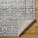 Surya Almeria low pile area rug in medium gray, gray, and cream with intricate floral patterns.