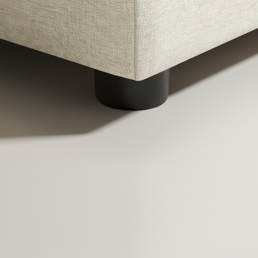 Close-up of a Surya Elenora modular chair's taupe polyester upholstery and black cylindrical leg.
