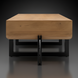 Minimalist Surya Lowmax coffee table with a brown mango wood top and black cast iron base.