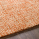 Surya Aiden AEN-1003 hand-tufted wool area rug in a vibrant burnt orange and ivory blend.