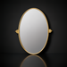 Surya Burnish oval wall mirror with an antiqued gold brass frame on a dark background.