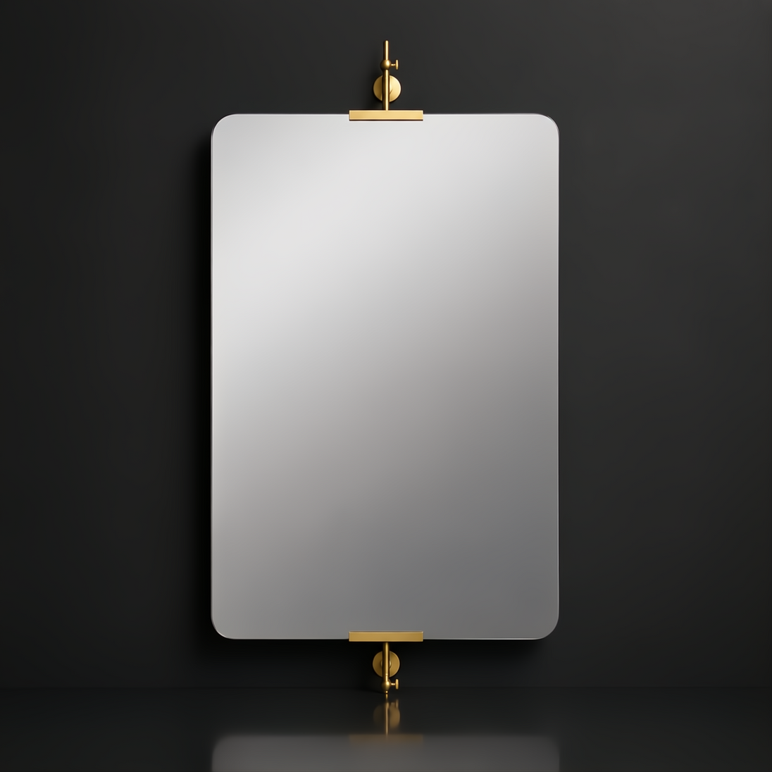 Rectangular mirror with rounded corners, suspended by elegant brass hardware on a dark wall.