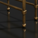 Close-up of the metallic brass iron base and legs of the Surya Engel coffee table.