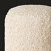 Close-up of a Surya Mohave Pouf, featuring a textured, creamy white bouclé-style fabric.