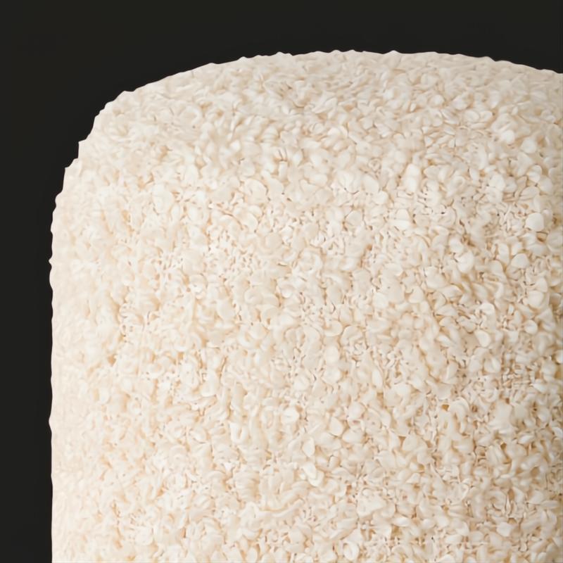 Close-up of a Surya Mohave Pouf, featuring a textured, creamy white bouclé-style fabric.