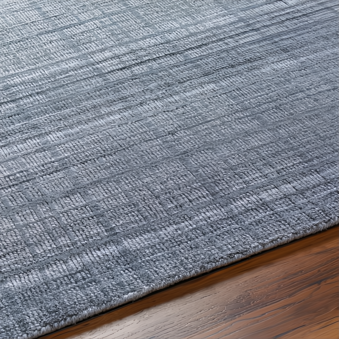 Surya Fresno FNO-2300-P hand-loomed area rug in multi-gray recycled PET yarn on wood floor.