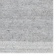 Hand-woven gray and white recycled PET yarn area rug with a subtle, textured pattern.