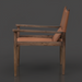 Modern Surya Chole accent chair with a tan leather top and dark mango wood frame, side view.