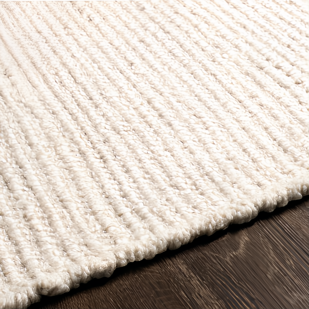 Surya Azalea AZA-2325 hand-woven ivory recycled PET yarn rug with ribbed texture on wood floor.